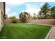 Artificial turf backyard with tree and block wall at 2304 S Abbey --, Mesa, AZ 85209