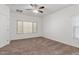 Spacious bedroom with ceiling fan and neutral colored carpet at 2304 S Abbey --, Mesa, AZ 85209