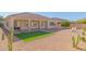 Artificial turf backyard with covered patio and citrus tree at 2410 W Aloe Vera Dr, Phoenix, AZ 85085