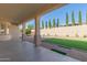 Covered patio overlooking a grassy backyard with firepit at 2410 W Aloe Vera Dr, Phoenix, AZ 85085