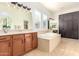 Elegant bathroom with double vanities and a large soaking tub at 2410 W Aloe Vera Dr, Phoenix, AZ 85085