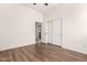 Bright bedroom with wood floors and sliding door closet at 2410 W Aloe Vera Dr, Phoenix, AZ 85085