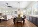 Dining area with a large table, hardwood floors, and built-in cabinets at 2410 W Aloe Vera Dr, Phoenix, AZ 85085