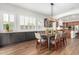 Bright dining room featuring a farmhouse table and large windows with plantation shutters at 2410 W Aloe Vera Dr, Phoenix, AZ 85085