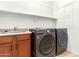 Laundry room with washer, dryer, and utility sink at 2410 W Aloe Vera Dr, Phoenix, AZ 85085