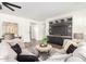 Living room with sectional sofa, built-in entertainment center, and hardwood floors at 2410 W Aloe Vera Dr, Phoenix, AZ 85085