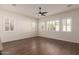 Bright living room featuring wood floors and plantation shutters at 2410 W Aloe Vera Dr, Phoenix, AZ 85085