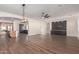 Open living room with hardwood floors, a ceiling fan, and built-in shelving at 2410 W Aloe Vera Dr, Phoenix, AZ 85085