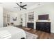 Main bedroom with hardwood floors and ceiling fan. Features a sitting area and built-in cabinetry at 2410 W Aloe Vera Dr, Phoenix, AZ 85085