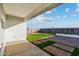 Covered patio overlooking artificial turf and pavers at 24111 W Flores Dr, Buckeye, AZ 85326