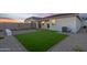 Artificial turf backyard with patio and sitting wall at 24111 W Flores Dr, Buckeye, AZ 85326