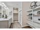 Modern bathroom with double vanity, shower, and shelving at 24111 W Flores Dr, Buckeye, AZ 85326