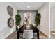 Modern dining room featuring a sleek table and stylish wall decor at 24111 W Flores Dr, Buckeye, AZ 85326