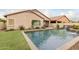 Inviting backyard pool with waterfall feature and grassy area at 2528 W Brookhart Way, Phoenix, AZ 85085