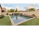 Refreshing backyard pool with a spacious deck and grassy area at 2528 W Brookhart Way, Phoenix, AZ 85085