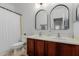 Clean bathroom with double vanity and arched mirrors at 2528 W Brookhart Way, Phoenix, AZ 85085