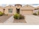 Tan house with a two-car garage and landscaped front yard at 2528 W Brookhart Way, Phoenix, AZ 85085