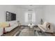 Living room features hardwood floors, white walls, and a large TV at 2528 W Brookhart Way, Phoenix, AZ 85085