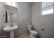 Simple, modern bathroom with pedestal sink and toilet at 2575 E Bluff Spring Ave, Apache Junction, AZ 85119