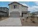 Two-story home with gray siding, two-car garage, and landscaped yard at 2575 E Bluff Spring Ave, Apache Junction, AZ 85119