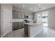 Modern kitchen with gray cabinets, granite island, and backyard access at 2575 E Bluff Spring Ave, Apache Junction, AZ 85119