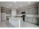 Modern kitchen with gray cabinets, granite island, and stainless steel appliances at 2575 E Bluff Spring Ave, Apache Junction, AZ 85119