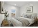 Bedroom with wood accents, neutral bedding, and window view at 2693 S 357Th Dr, Tonopah, AZ 85354