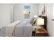 Bedroom with striped bedding, wood nightstand, and window view at 2693 S 357Th Dr, Tonopah, AZ 85354