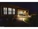 Night view of covered patio with fireplace and outdoor seating area at 27028 W Oraibi Dr, Buckeye, AZ 85396