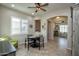 Bright dining area with a round table, seating for four, and access to other rooms at 27028 W Oraibi Dr, Buckeye, AZ 85396