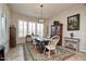 Charming dining area with a wood table and white chairs at 27028 W Oraibi Dr, Buckeye, AZ 85396