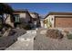 Single-story home with stucco exterior, landscaped yard, and two-car garage at 27028 W Oraibi Dr, Buckeye, AZ 85396