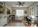 Bright home office featuring two workspaces and plantation shutters at 27028 W Oraibi Dr, Buckeye, AZ 85396