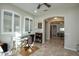 Home office with desk, chair, and view into adjacent hallway at 27028 W Oraibi Dr, Buckeye, AZ 85396