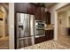 Kitchen features stainless steel appliances and dark wood cabinets at 27028 W Oraibi Dr, Buckeye, AZ 85396