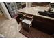 Granite kitchen island with drawers, trash pull-out, and a farmhouse sink at 27028 W Oraibi Dr, Buckeye, AZ 85396