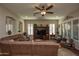 Living room with sectional sofa, armchairs, and built-in entertainment center at 27028 W Oraibi Dr, Buckeye, AZ 85396