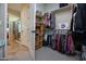 Spacious walk-in closet with shelving and hanging rods at 27028 W Oraibi Dr, Buckeye, AZ 85396