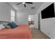 Main bedroom with coral bedding, mounted TV, and access to en-suite bath at 2732 E Trail Blazer Dr, San Tan Valley, AZ 85140