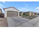 Two-car garage and driveway with desert landscaping at 2732 E Trail Blazer Dr, San Tan Valley, AZ 85140