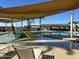 Community pool with a water playground, shade structures, and lounge chairs at 2929 E Birdsong Ave, San Tan Valley, AZ 85143