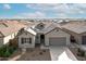 Single-story home with gray exterior, two-car garage, and landscaping at 2929 E Birdsong Ave, San Tan Valley, AZ 85143