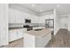 L-shaped kitchen with island, stainless steel appliances, and light countertops at 2929 E Birdsong Ave, San Tan Valley, AZ 85143