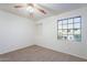 Bright bedroom with ceiling fan and window at 2929 E Broadway Rd # 13, Mesa, AZ 85204