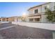 Two-story house with white brick and gray siding, a small front yard, and a gate at 2929 E Broadway Rd # 13, Mesa, AZ 85204