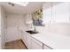 Kitchen with white cabinets, a stainless steel sink, and tiled floors at 2929 E Broadway Rd # 13, Mesa, AZ 85204