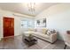 Living room with a brown door, a large window, and wood-look floors at 2929 E Broadway Rd # 13, Mesa, AZ 85204