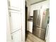 White cabinets and stainless steel refrigerator in updated kitchen at 303 N Lindsay Rd # N12, Mesa, AZ 85213