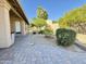 Paver patio and desert landscaping with mature trees define this backyard at 3106 E Hiddenview Dr, Phoenix, AZ 85048