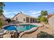 Inviting backyard pool with rock features, desert landscaping, and a covered patio at 3106 E Hiddenview Dr, Phoenix, AZ 85048